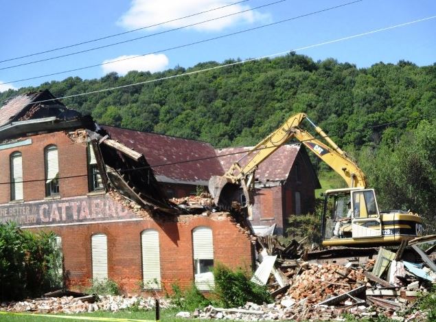 destruction of Cattaraugus Cutlery south building after August 2015 fire partially destroyed facade of south building, Cattaraugus Cutlery factory with machinery chewing away at remainder