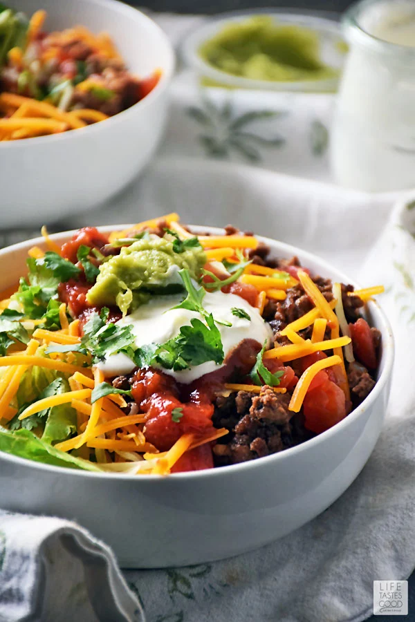 Taco Rice Bowl loaded with Mexican flavors served in a bowl with guacamole and sour cream