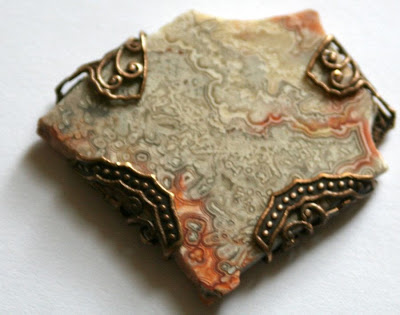 Flat stone wrapped in Vintaj filigree butterfly :: All Pretty Things