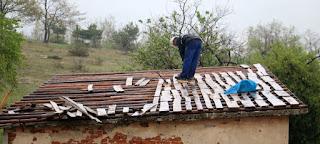 Bekir working on the roof in the cold rain Bekir working on the roof in the cold rain
