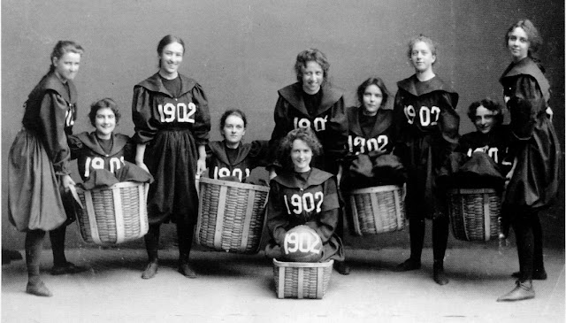 Smith College Class of 1902 girls basketball team. Player hold up teammates sitting in baskets. Baskets and Ladders. marchmatron.com Smith College Class of 1902 girls basketball team. Player hold up teammates sitting in baskets. Baskets and Ladders. marchmatron.com