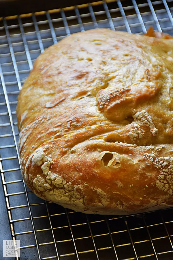 Crusty Artisan Style Bread | by Life Tastes Good has a wonderfully tangy flavor with a crispy outside and soft, chewy inside. With this no-knead recipe, it's easy to craft homemade bread just like the bakery! Makes a lovely hostess gift with a bottle of wine, and it's perfect for Thanksgiving! #LTGrecipes