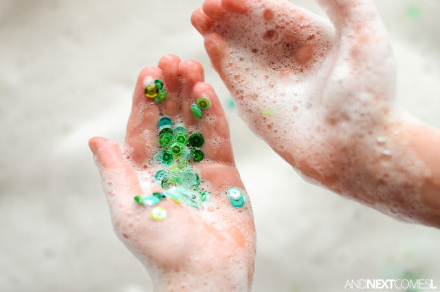 Add sequins to soap foam for a fun sensory bin idea for kids from And Next Comes L