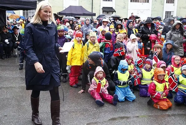 Crown Princess Mette-Marit wore Valentino coat and she wore Prada Brown Knee High Crocodile Boots. Telemark Rjukan-Notodden heritage site