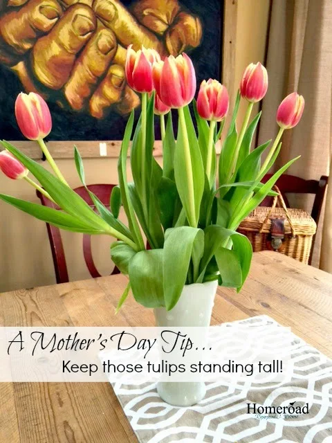 tulips in a white vase with a pinterest overlay