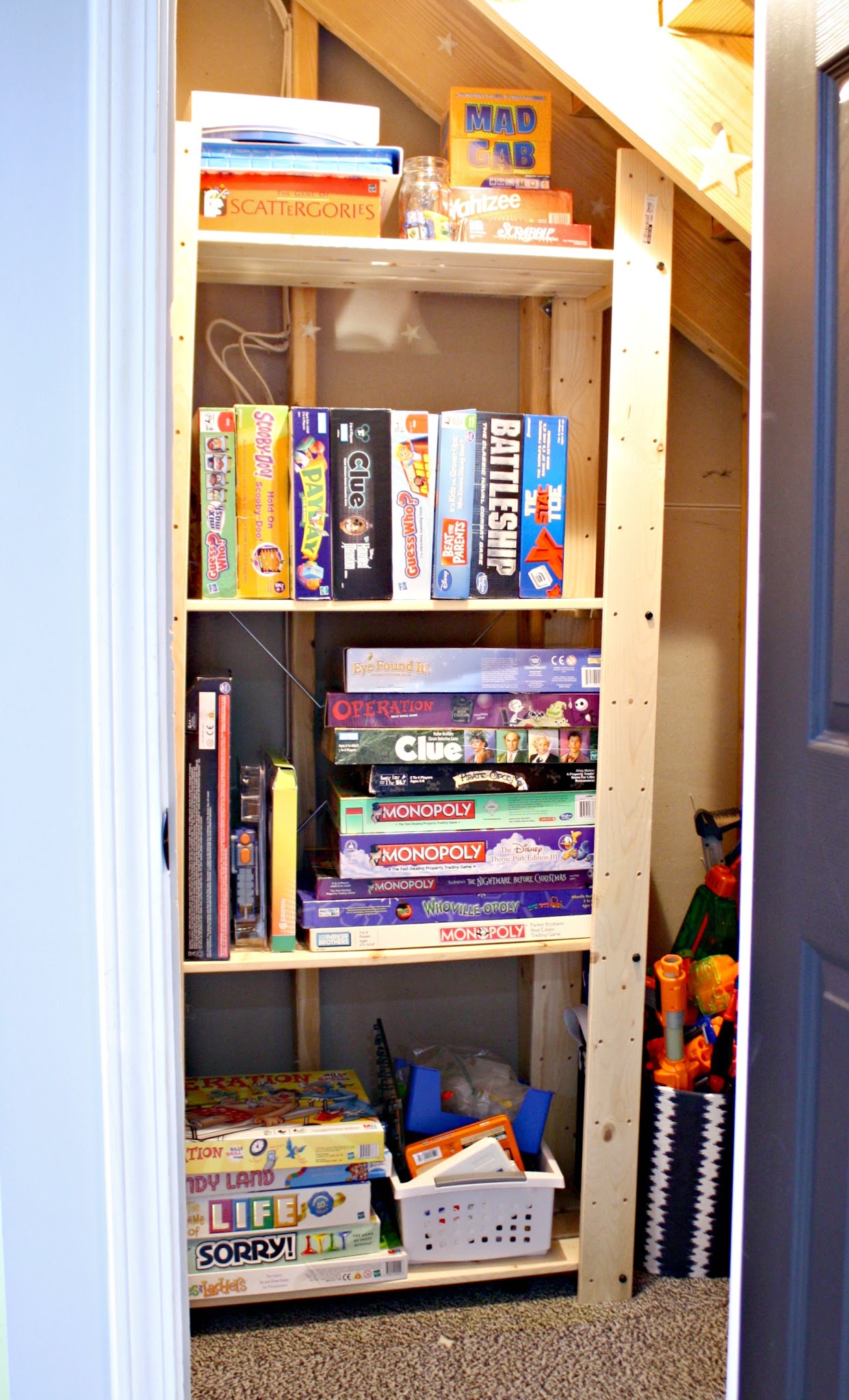 small bookcase under stairs