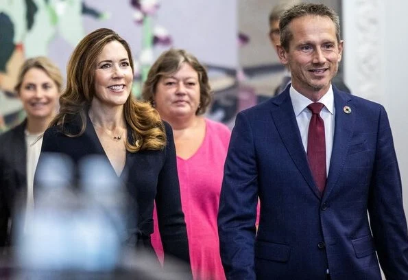 Scanlan Theodore crepe Knit wrap jacket and wide-leg trousers. Crown Princess Mary wore a crepe knit wrap jacket from Scanlan Theodore