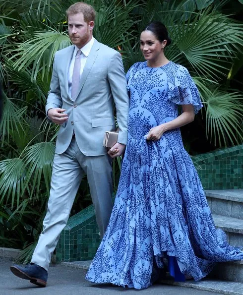Meghan Markle wore Carolina Herrera floral printed silk chiffon short sleeve gown, and she carries Dior Bee embellished clutch