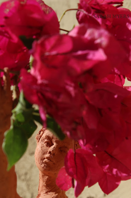 sculpture, terracotta, kneeling, woman, sarah, myers, red, clay, dance, figure, arte, escultura, figurative, classic, human, lady, poise, earthenware, orange, flowers, bougainvillea, detail, close-up, macro, face, head, nose, eyes, small