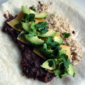 giant burrito with refried black beans, brown rice, avocado, cheddar, cilantro