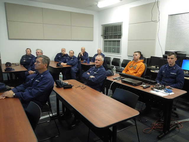 Flotilla members and active duty personnel listen attentively Flotilla members and active duty personnel listen attentively