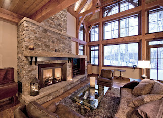 Stony Rustic Fireplace Mantels to Decorate Your Rustic Living Room Traditional Living Room with Fluffy Sofas and the Glass Table facing the Stone Rustic Fireplace Mantels