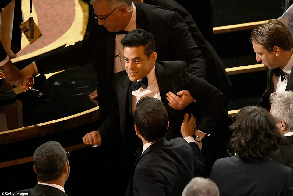 Watch The moment Rami Malek 'fell off the stage' following his best
