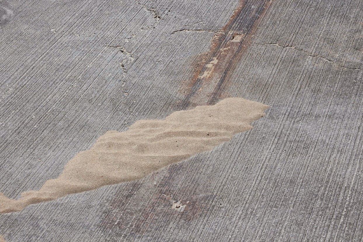 splash of sand on a concrete surface 