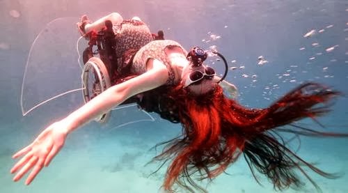 woman in wheelchair, underwater, with scuba gear