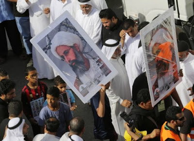 Saudis carry a poster demanding freedom for jailed Shiite cleric Sheikh Nimr al-Nimr Saudis carry a poster demanding freedom for jailed Shiite cleric Sheikh Nimr al-Nimr