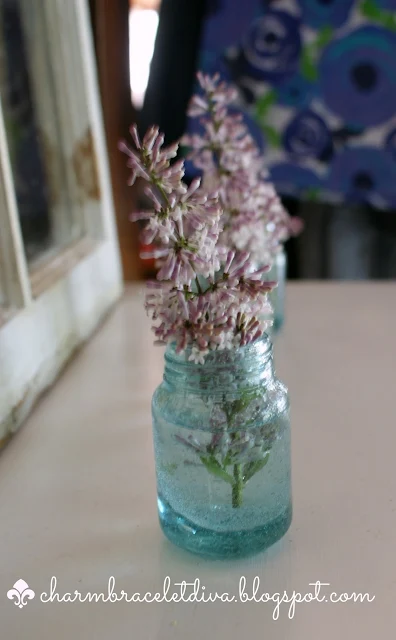 lilacs displayed in mini glass vases