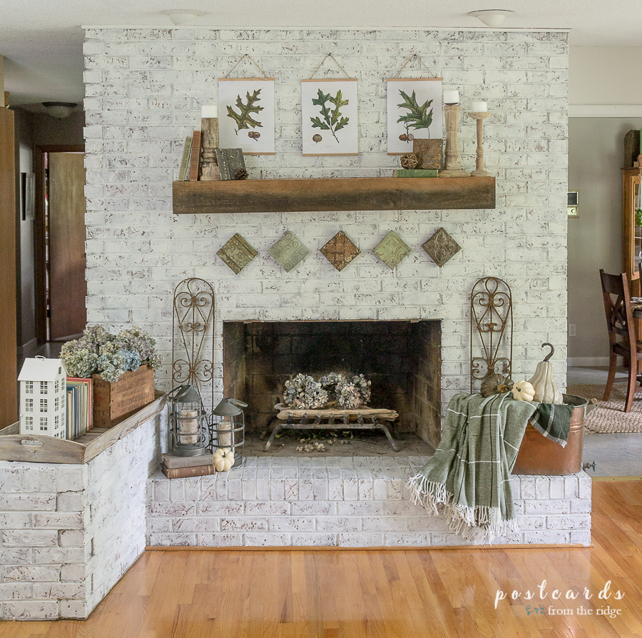 white brick fireplace with fall decor