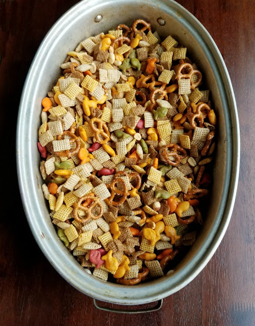large roasting pan filled with chex mix ingredients ready to bake