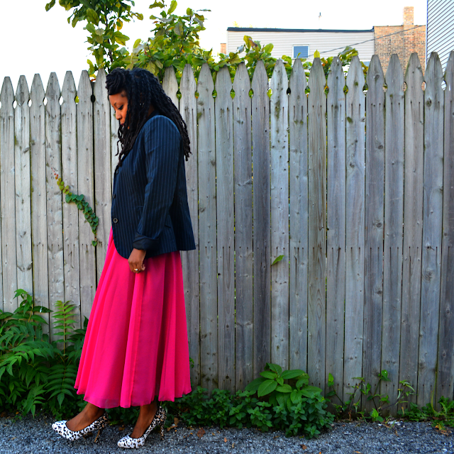 pinstripe blazer worn with a pink tea length skirt