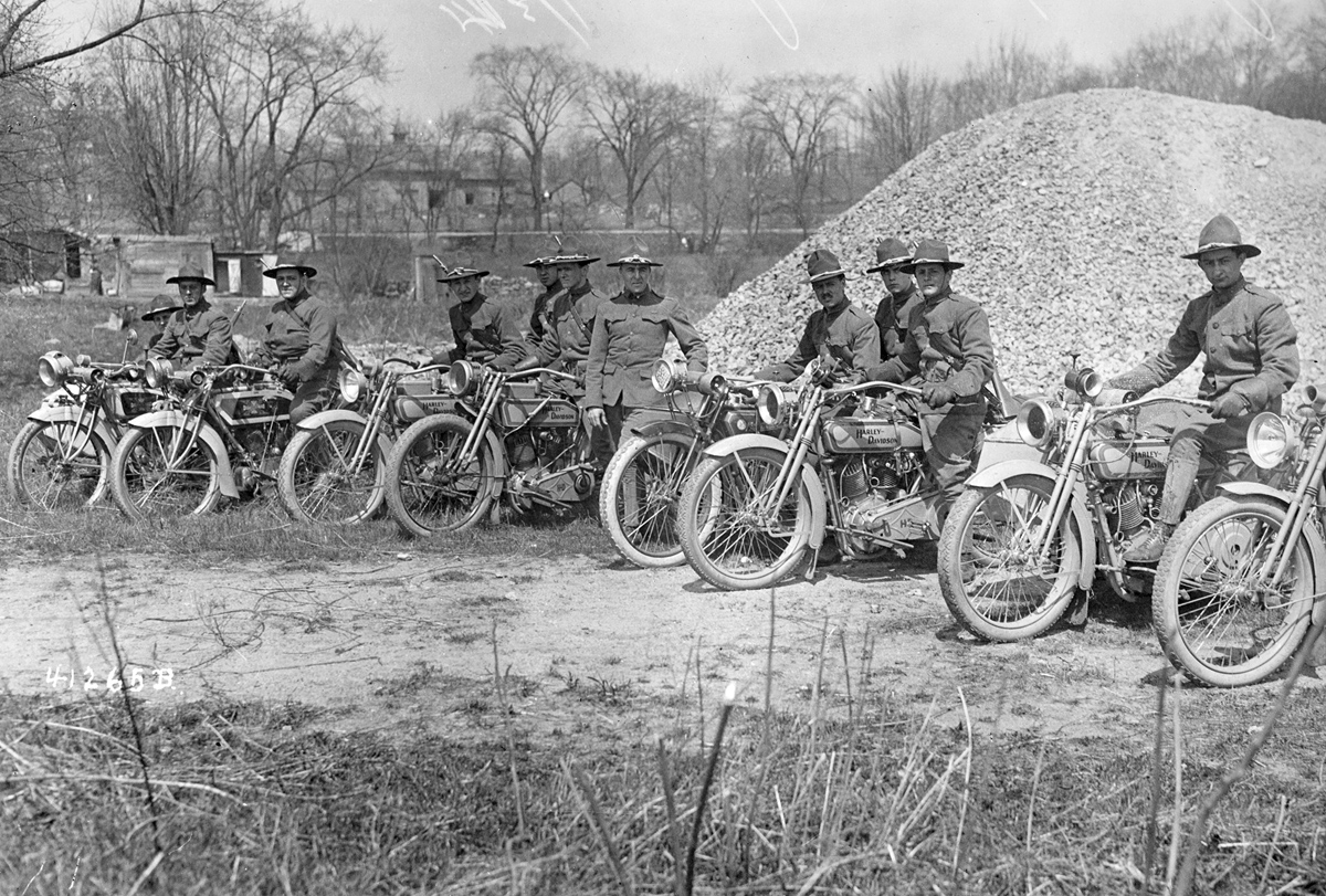 Men sit astride their Harley-Davidson motorcycles, part of the New York National Guard's Motorcycle Division, circa 1917.