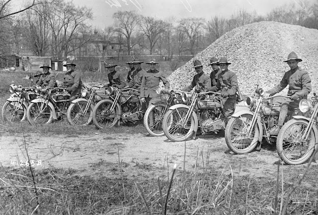 Men sit astride their Harley-Davidson motorcycles, part of the New York National Guard's Motorcycle Division, circa 1917.