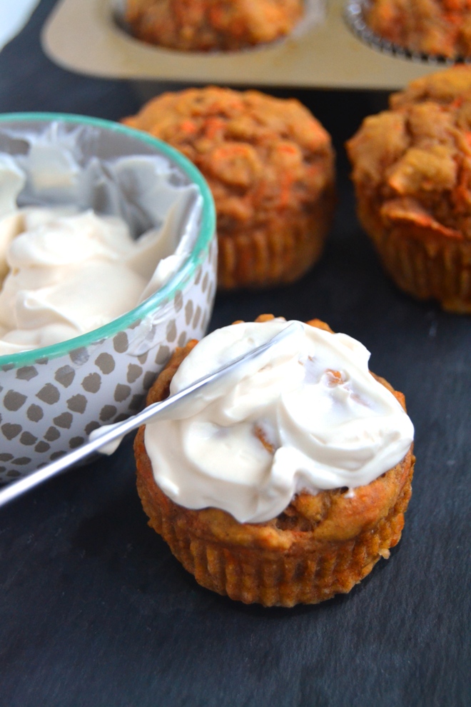Greek Yogurt Carrot Cake Muffins are whole-grain, super moist and topped with a delicious Greek yogurt cream cheese frosting and walnuts! www.nutritionistreviews.com