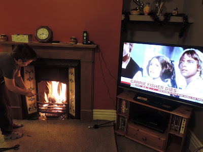 boy poking house fire