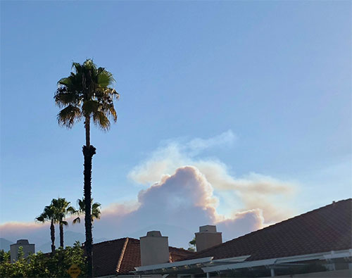 Fire clouds from the Holy Fire, miles away, rise above the observatory rooftops (Source: Palmia Observatory)