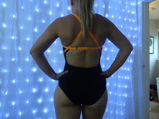 back of swim suit with orange detailing