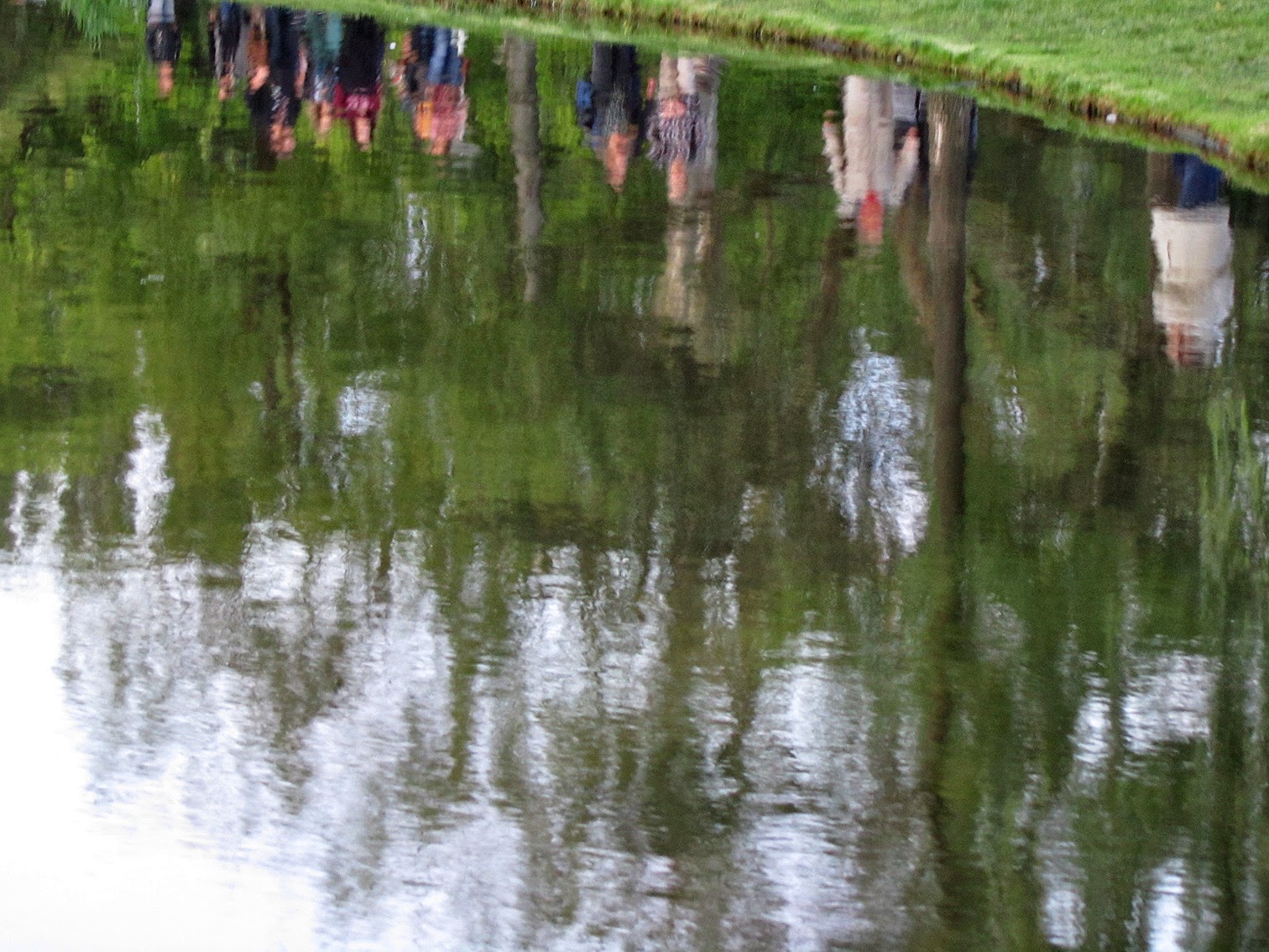 reflection of people in a pond