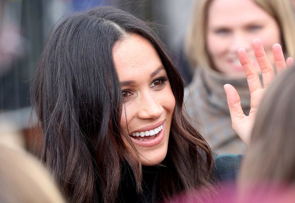 Meghan Markle wore a double-breasted tartan wool-blend coat by Burberry during Edinburgh visit. Meghan carried Strathberry Mini crossbody bag