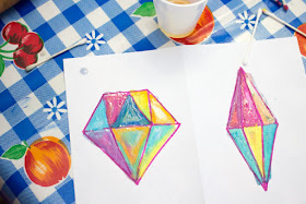 "Painting" with oil pastels to create beautiful "crystal" sun catchers with kids