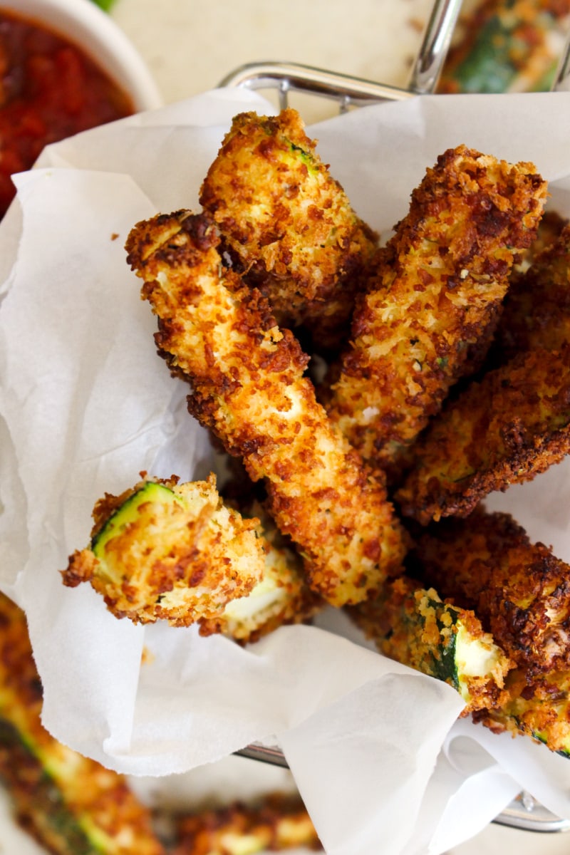 Air Fryer Zucchini Fries are coated in a seasoned panko and parmesan cheese coating making them a crispy and delicious side dish or snack. #airfryer #zucchini