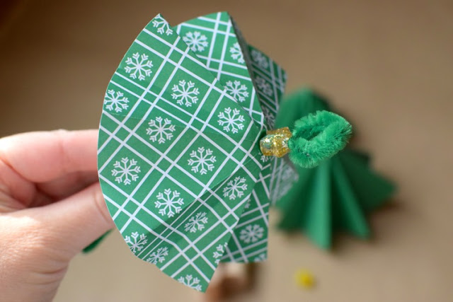 Folded paper Christmas tree ornament craft for kids. Origami is a great fine motor work activity for kindergarten or elementary children!