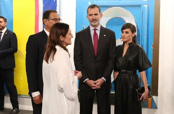 Queen Letizia wore &Other Stories Belted Leather Midi Dress, Prada nude pumps and carried Uterque clutch bag