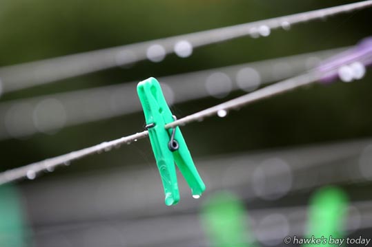 Wet pegs on a wet washing line - wet weather, rain forecast for the rest of the week. Wet pegs on a wet washing line - wet weather, rain forecast for the rest of the week. photograph