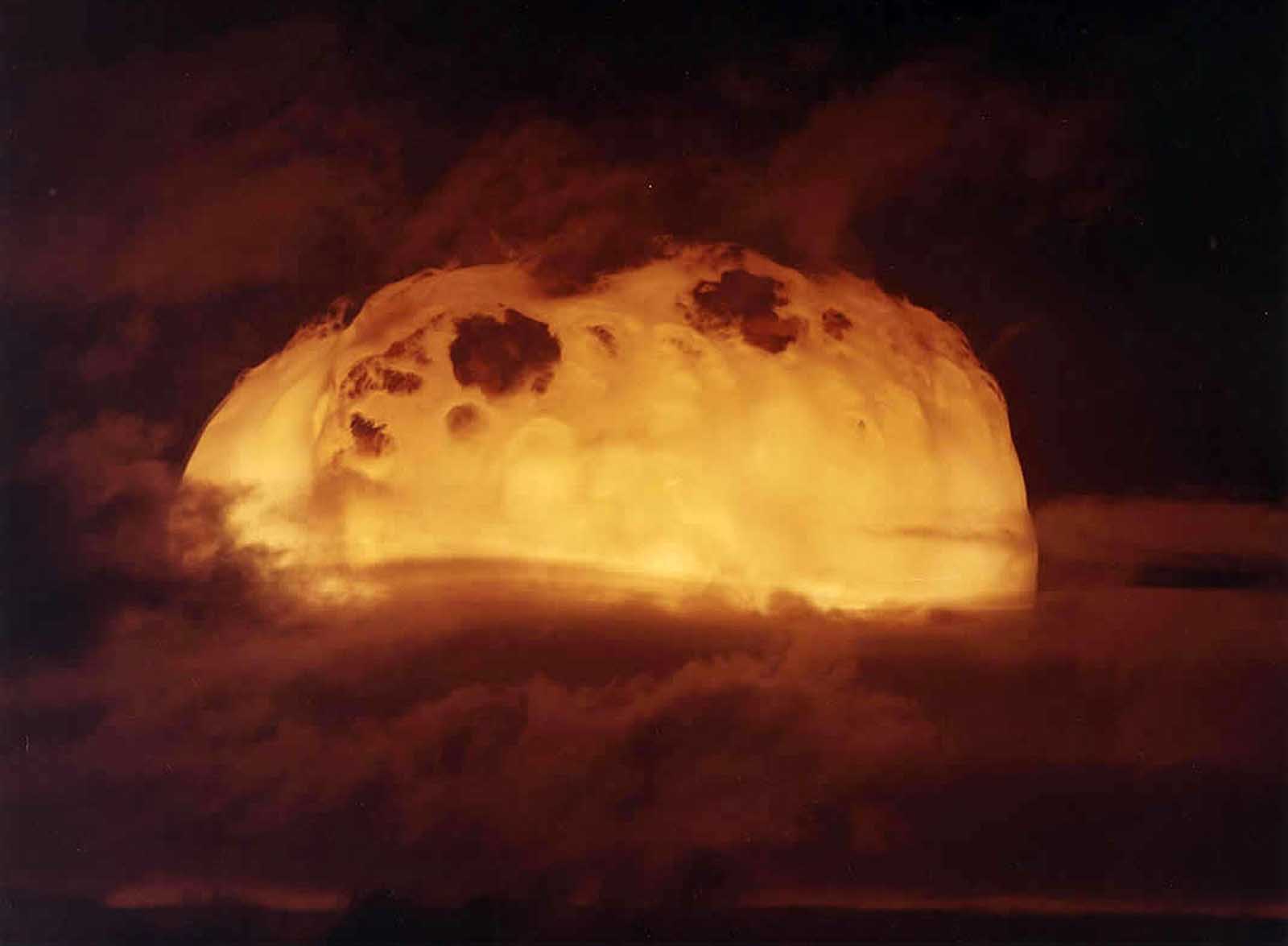 The rising fireball of the Aztec test, part of Operation Dominic, a series of over 100 nuclear test explosions in Nevada and the Pacific in 1962.