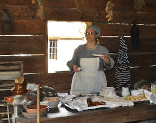 woman dressed as colonial texan cook with food