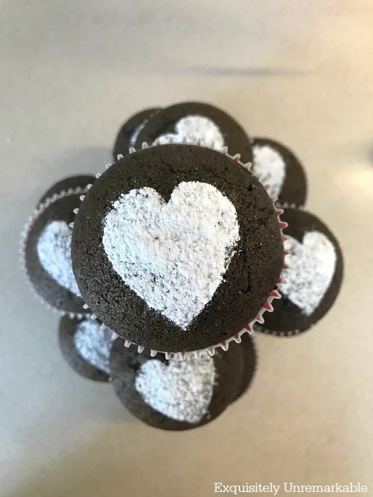 Easy Vegan Chocolate Cupcakes with powdered sugar hearts in a pyramid