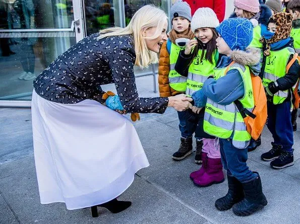 Crown Princess Mette-Marit wore a new silk wool jacket by Brock Collection, and pleated midi skirt. Deichman Library children's books