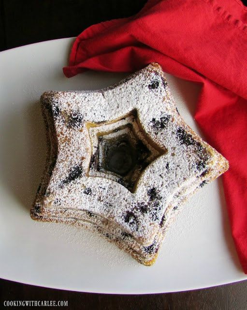 This recipe is adapted from the White House Pastry Chef's recipe for blueberry bundt cake. It is delicious, easy and perfect for spring, President's Day or 4th of July! star shaped bundt cake with blueberries in the cake and powdered sugar on top