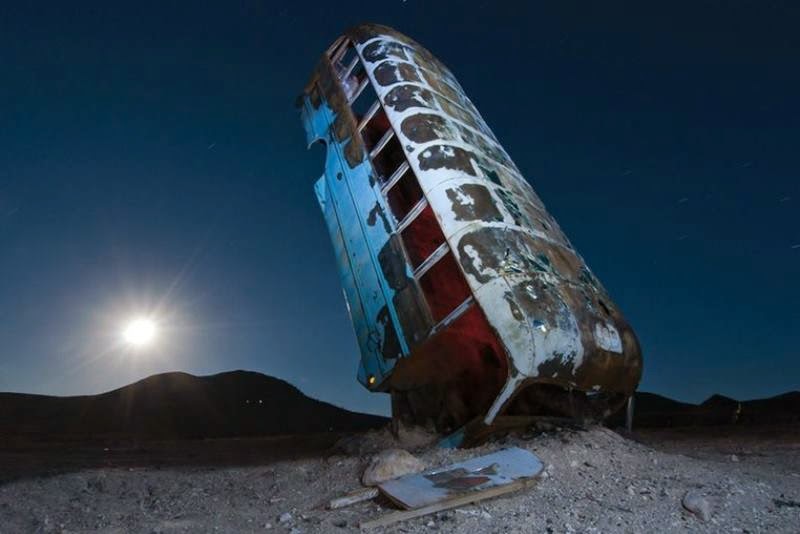 At the edge of Goldfield, a small town in the middle of Nevada, multiple cars, buses, vans, and limos are buried vertically in the desert as if they are growing out of the ground.