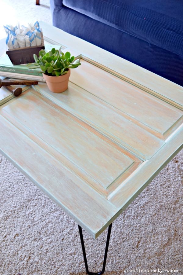 Amazing Makeover Alert! Turn an old door into a gorgeous weathered farmhouse style coffee table in just a few simple steps!