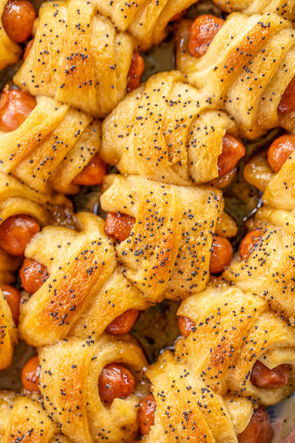 Glazed Pigs in a Blanket - pigs in a blanket baked in a sweet and savory brown sugar glaze. Took these to a party and they were gone in minutes!!! Crescent rolls, dijon mustard, little smokies, brown sugar, butter, poppy seeds and Worcestershire sauce. I have zero self-control around these things! Dangerously delicious!! A MUST for all your tailgates and parties! #tailgating #Pigsinablanket #partyfood #appetizer Glazed Pigs in a Blanket - pigs in a blanket baked in a sweet and savory brown sugar glaze. Took these to a party and they were gone in minutes!!! Crescent rolls, dijon mustard, little smokies, brown sugar, butter, poppy seeds and Worcestershire sauce. I have zero self-control around these things! Dangerously delicious!! A MUST for all your tailgates and parties! #tailgating #Pigsinablanket #partyfood #appetizer
