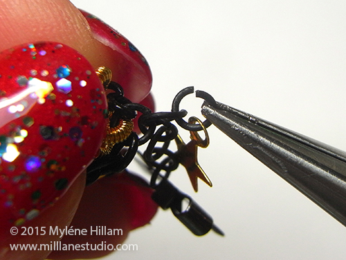 Attaching the gold star charm dangle.