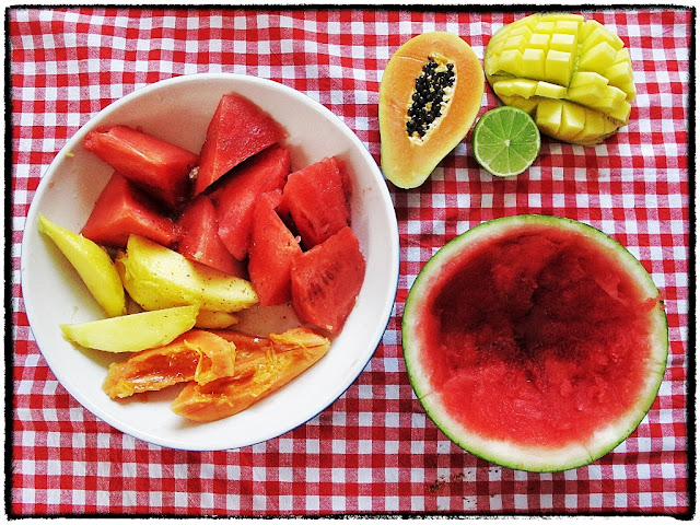  tropical fruit with chilli and lime in a watermelon bowl