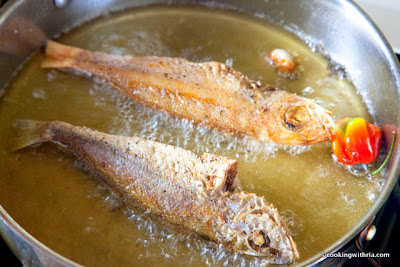 Photo of fish frying in hot oil