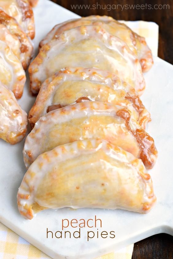 Dessert is ready in 30 minutes with these Glazed Peach Hand Pies! The flaky crust and spicy cinnamon filling are the perfect combo in a hand pie, plus they're baked not fried! More #dessert