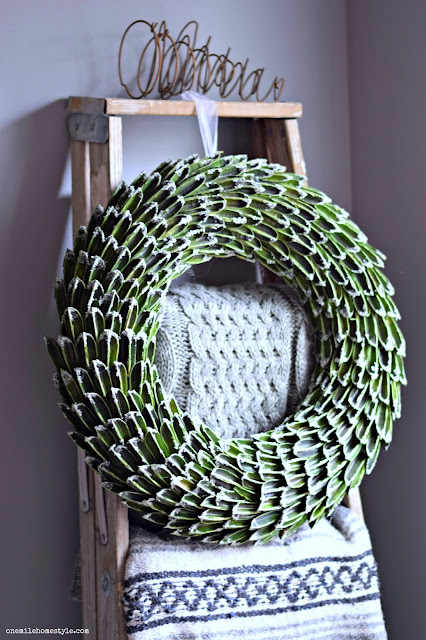 Frosted wreath winter accent on a rustic blanket ladder Frosted wreath winter accent on a rustic blanket ladder